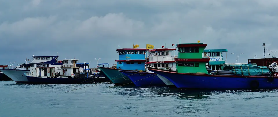 Passenger and cargo vessels moored side by side at the quay in Malé harbour.