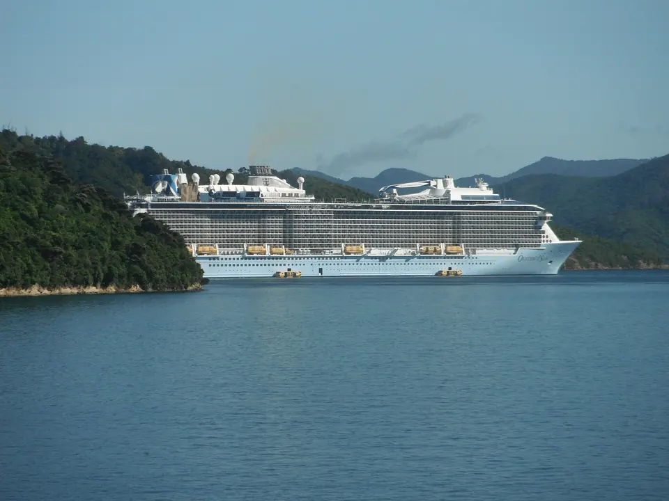 Cruise vessel at anchor in a sheltered coastal channel.